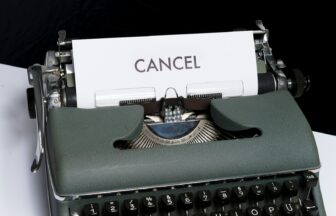 green and white typewriter on black textile